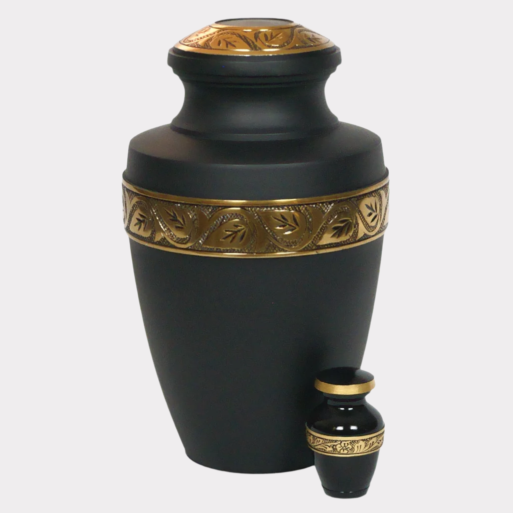 Black keepsake urn with gold leaf and flower detailing next to matching full size urn