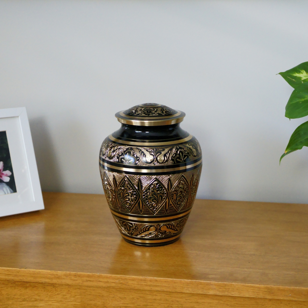 Brass urn with butterfly details