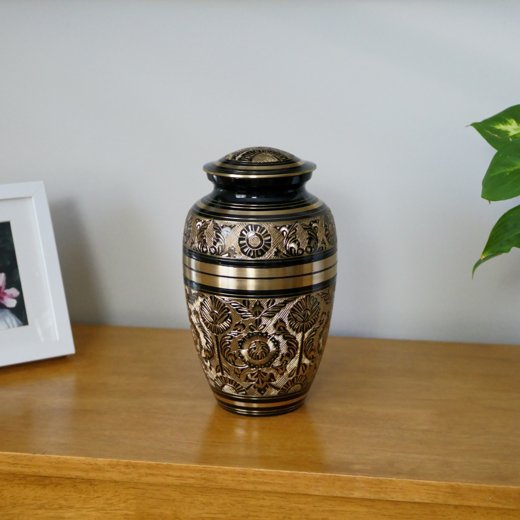 brass urn with flower and nature details