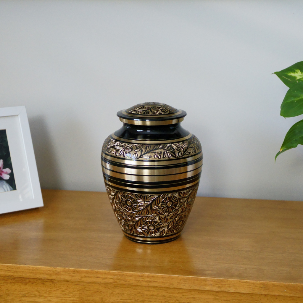 brass urn with floral and nature patterns